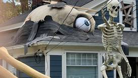 Man builds a skeleton bursting out of his house for Halloween, and it’s pretty incredible